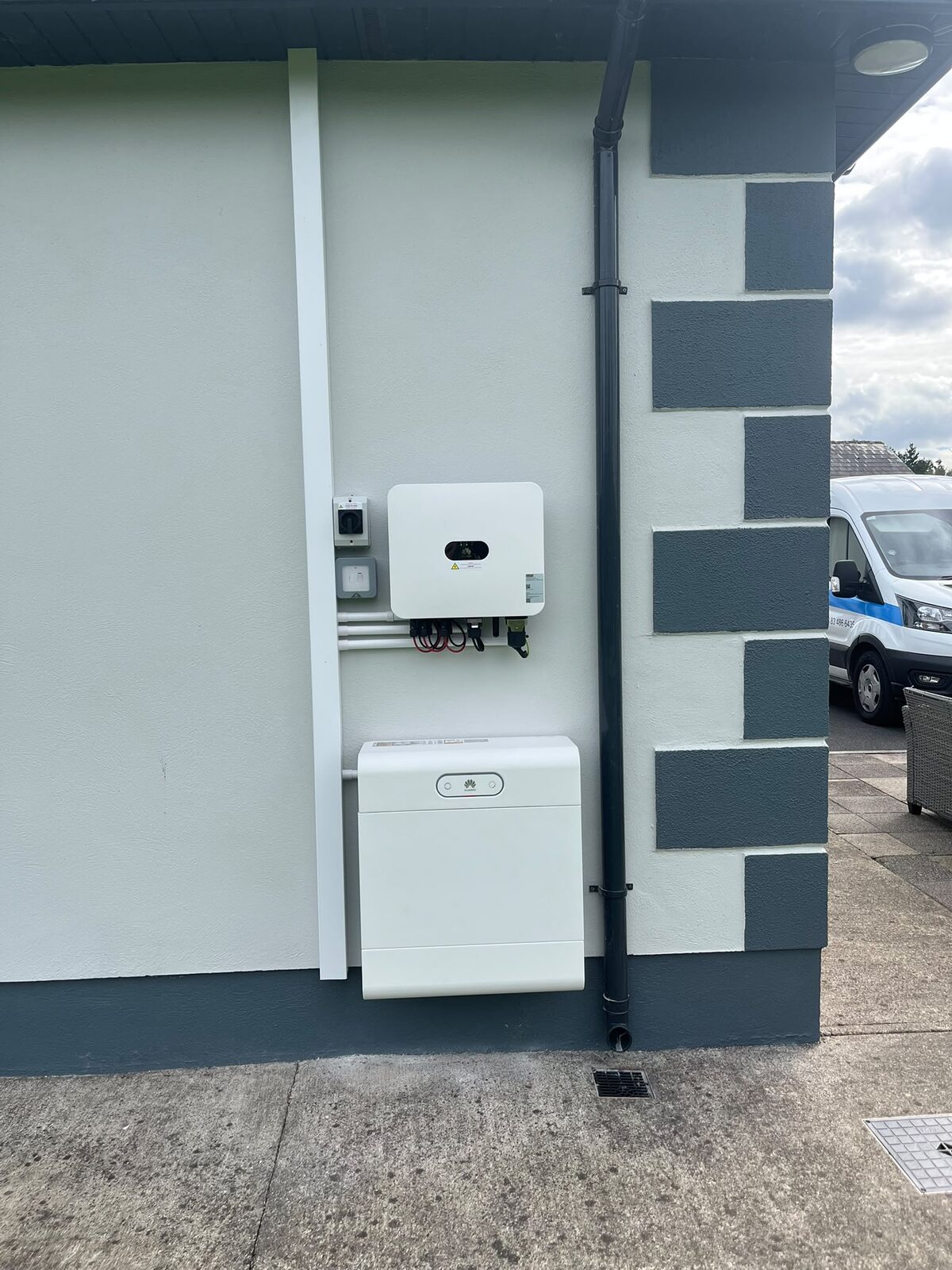 Inverter and battery installed on an exterior wall