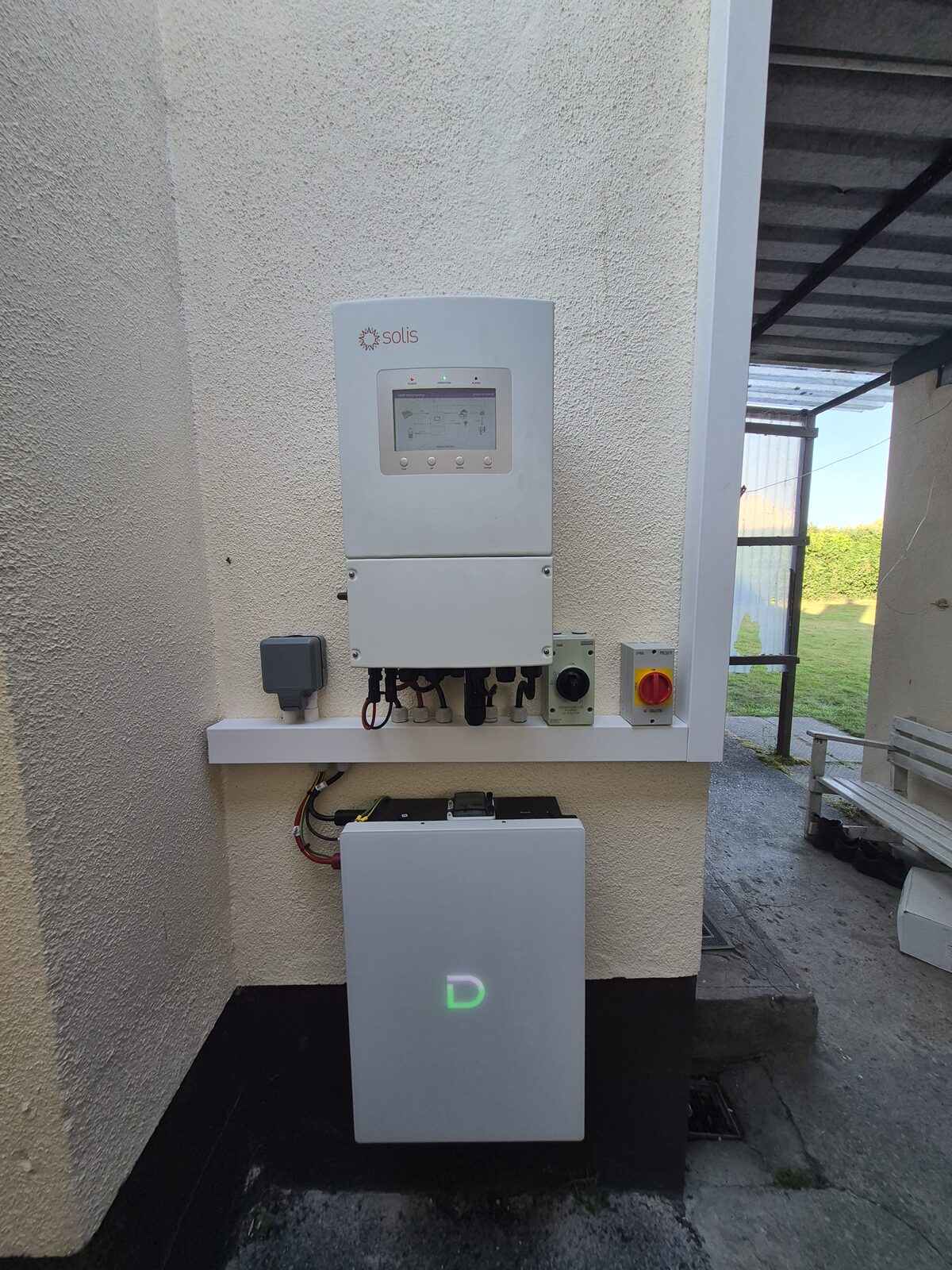 Home battery and inverter installed beside a house