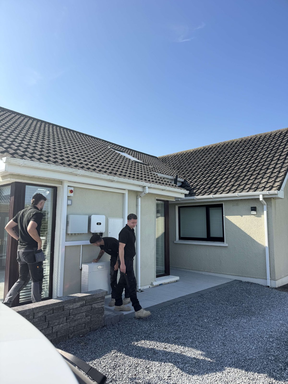 Lux electricians fitting an inverter and consumer unit on site