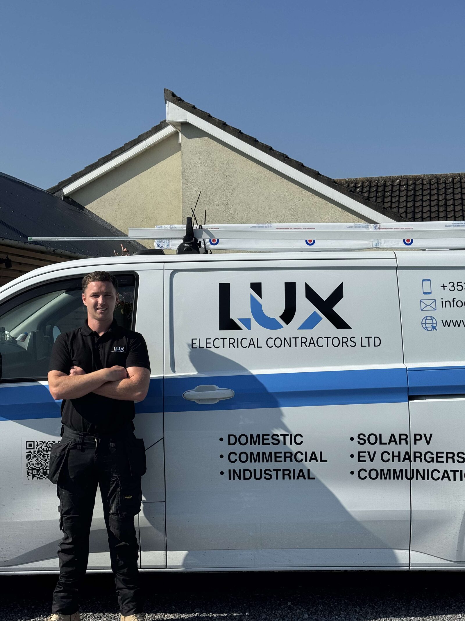Dean from Lux Electrical & Renewables beside the company van