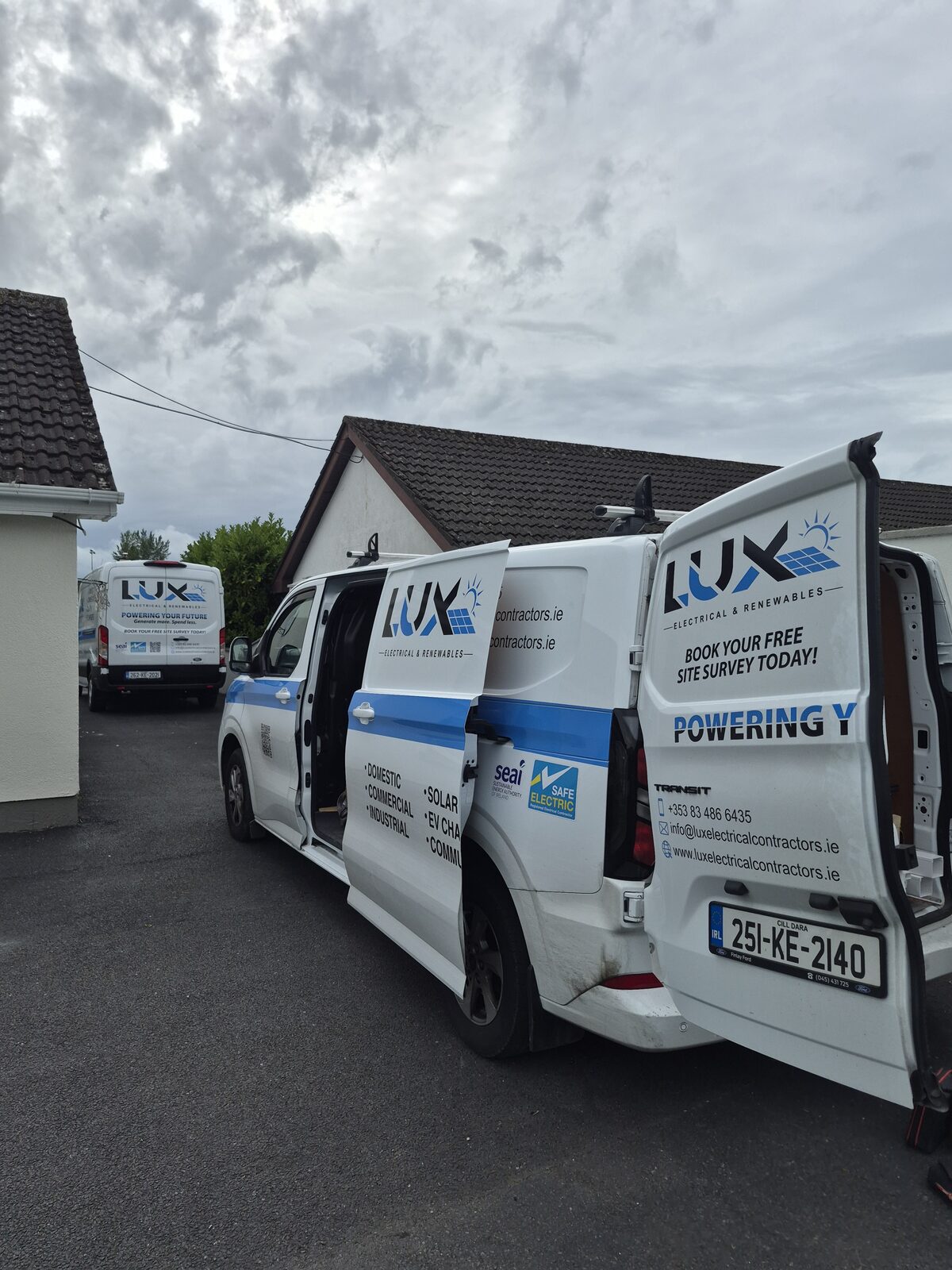 Lux vans outside a home during a solar install