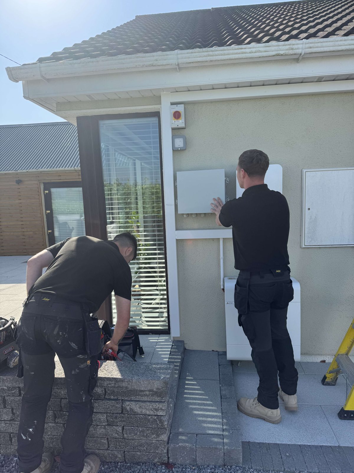 Two Lux electricians working on an install